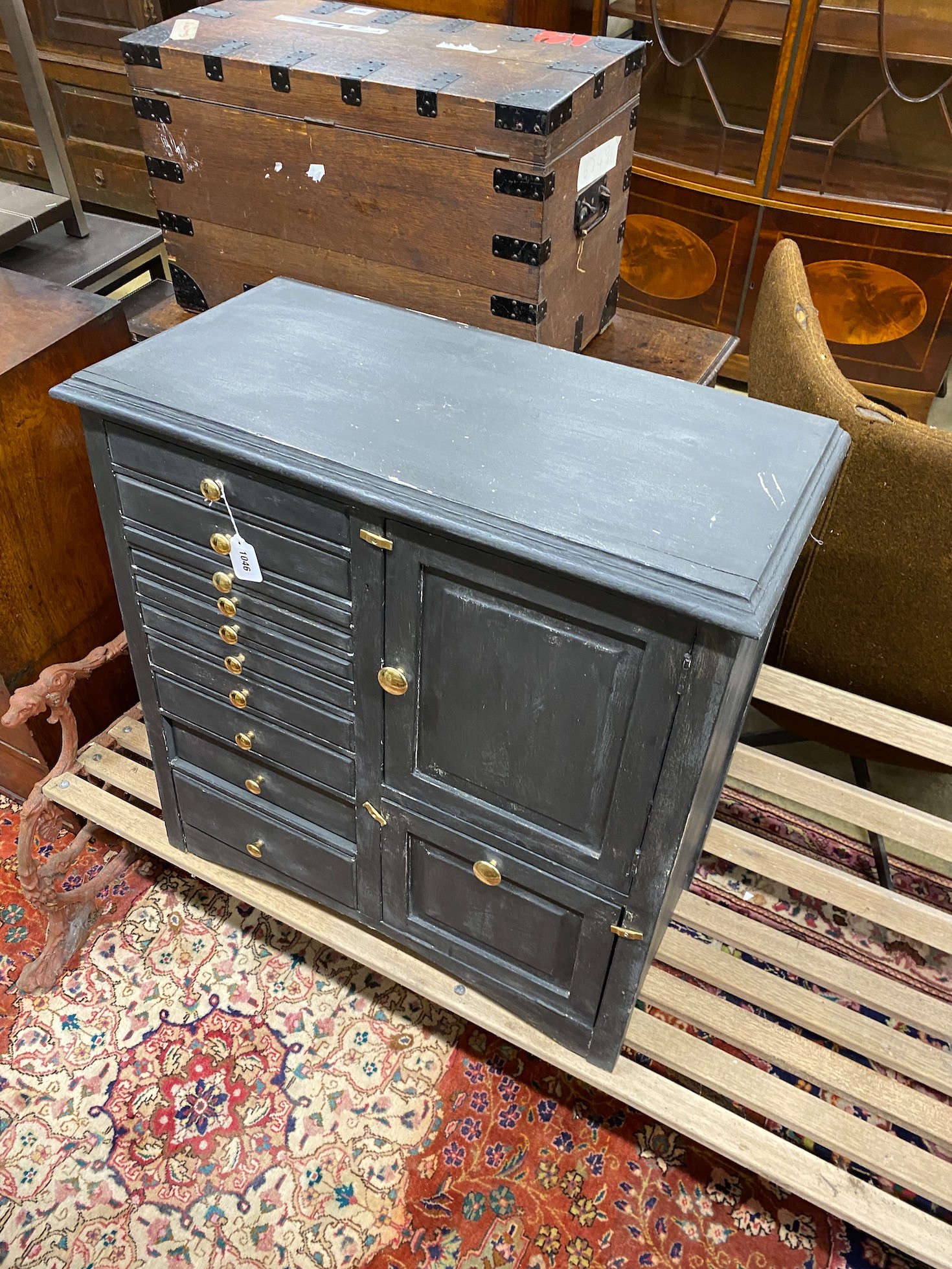 An early 20th century grey painted dentist's cabinet with nine drawers, a slide and two cupboards, width 77cm, height 78cm